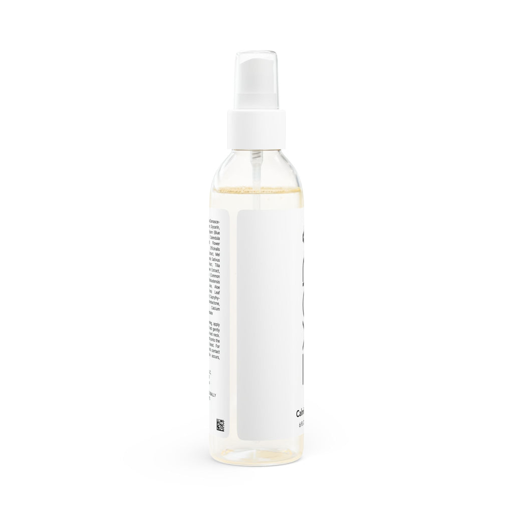 Clear spray bottle with a white label on a white background