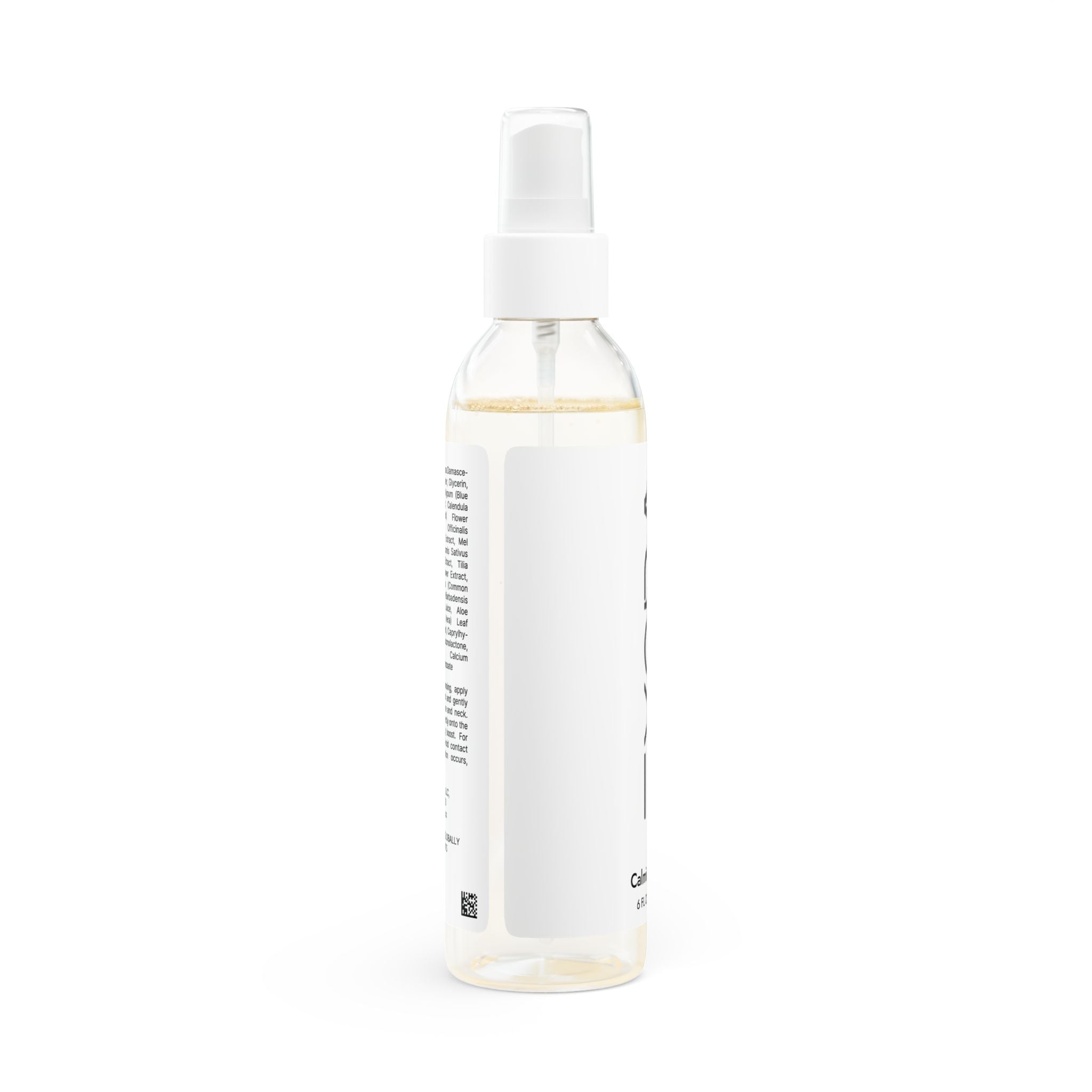 Clear spray bottle with a white label on a white background