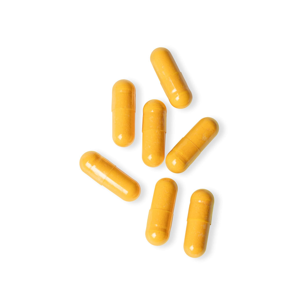 Yellow capsules on a white background