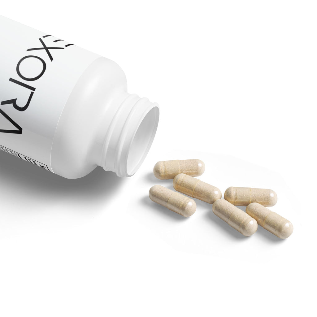 White bottle of 'EXORA' supplements with wooden capsules on a white background