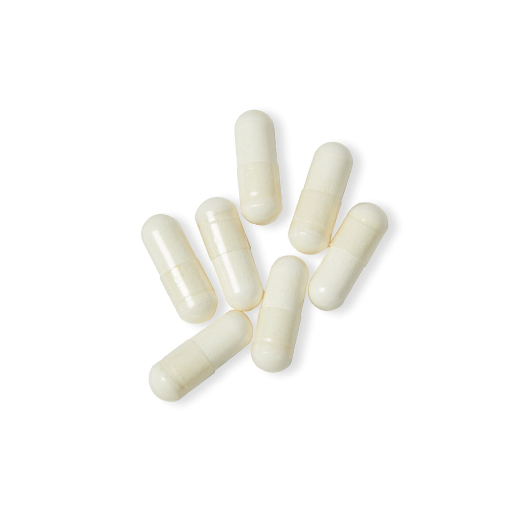 White capsules on a white background