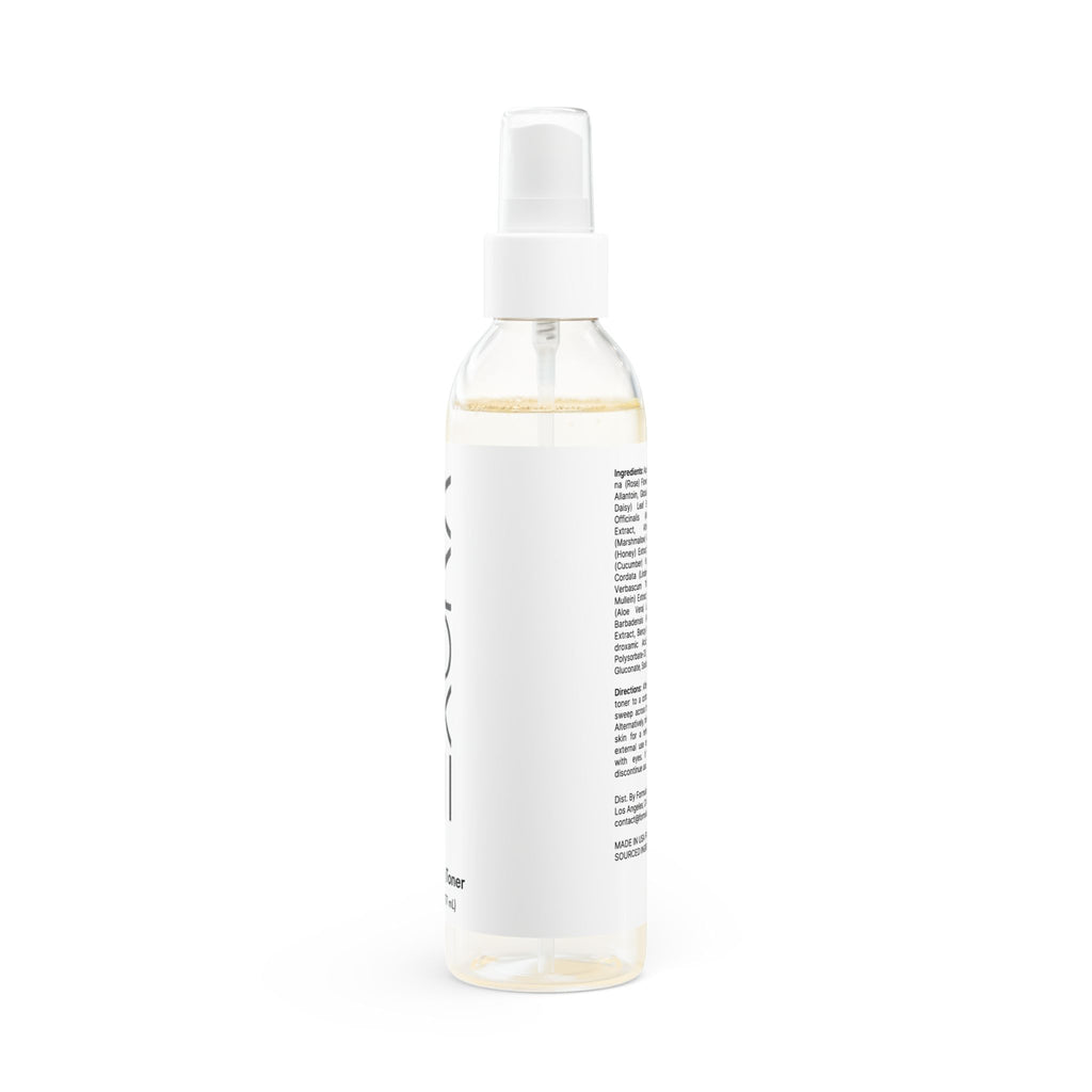 White spray bottle with a label on a white background