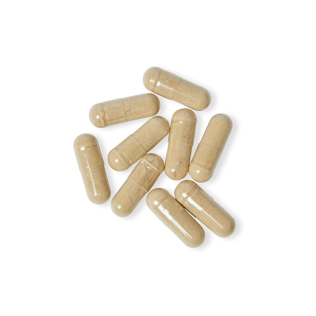 Beige capsules on a white background