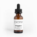 Exora Vitamin C serum bottle with dropper on a white background