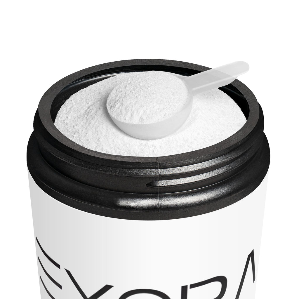 Container of white powder with a scoop on a white background