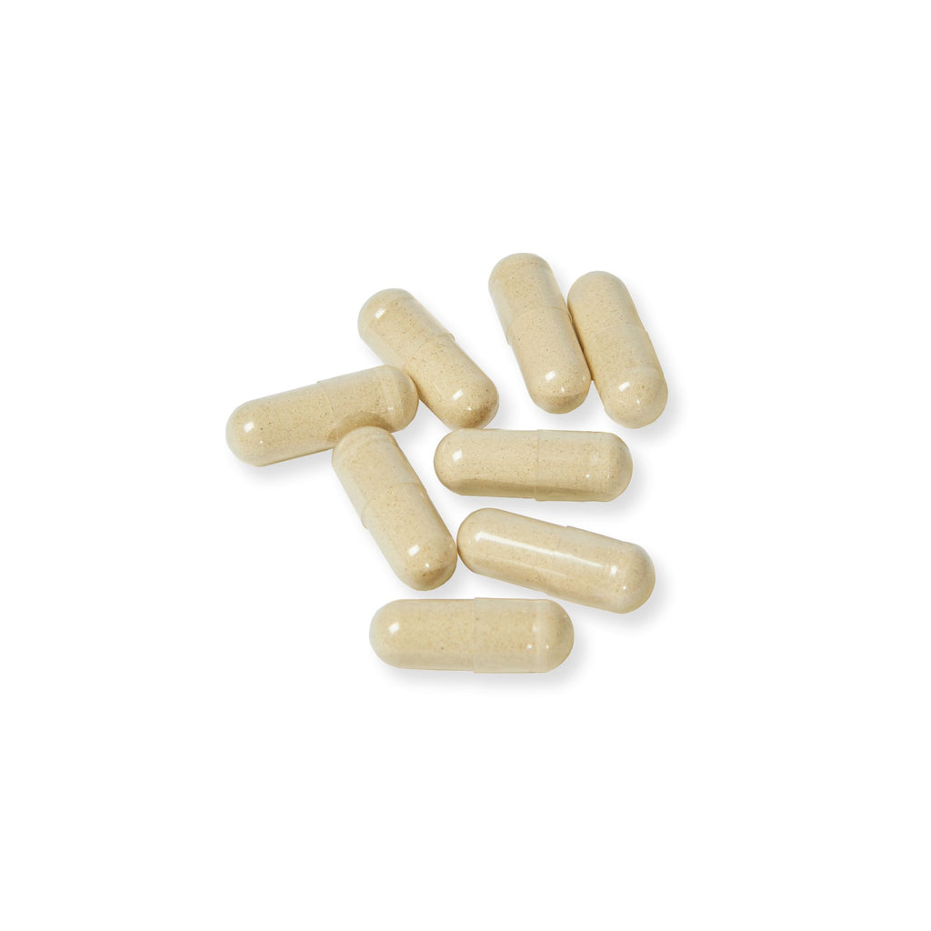 Beige capsules on a white background