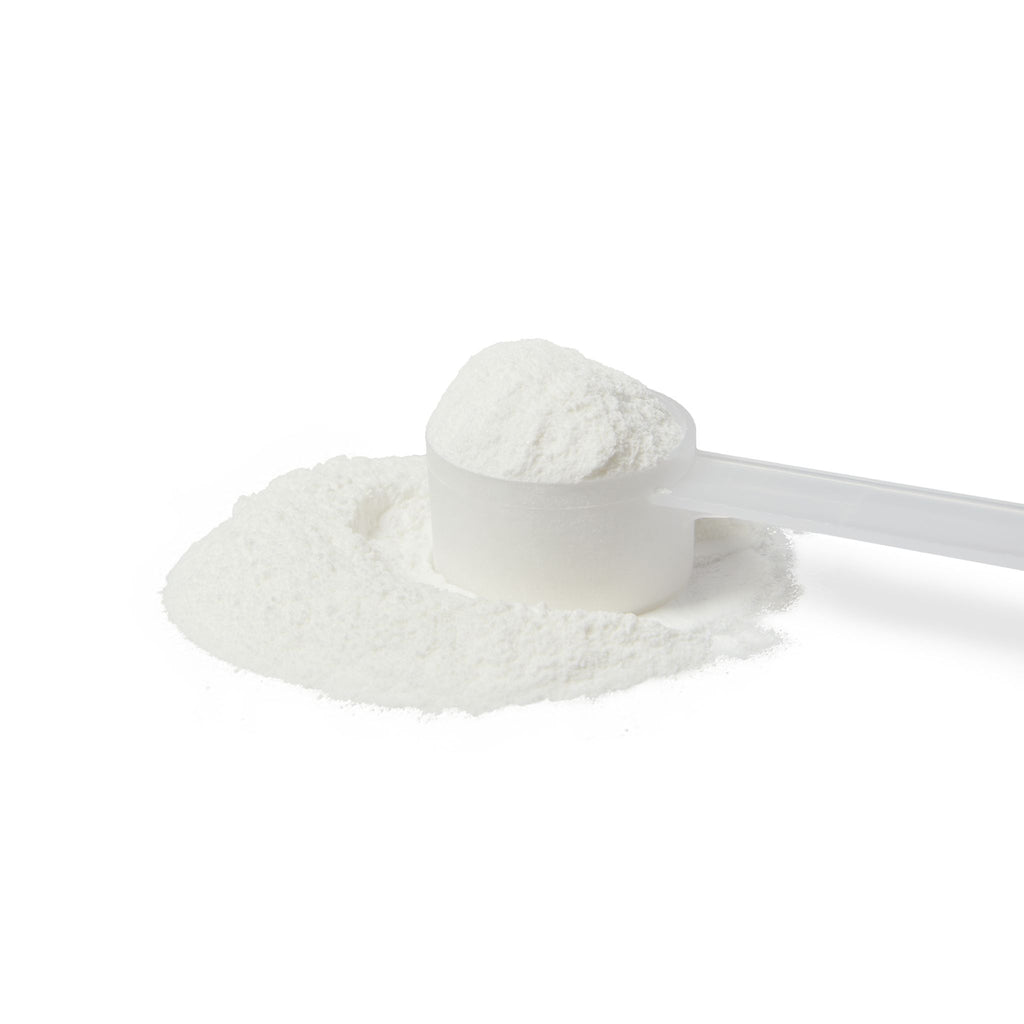 White powder in a measuring spoon on a white background